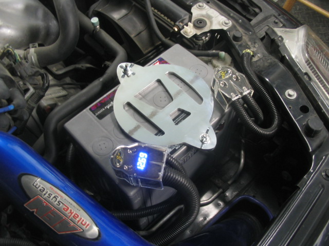 Honda logo battery hold-down with SVR battery and Stinger voltage display 