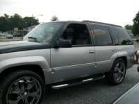 Custom two-tone black and silver paint and spinning chrome rims